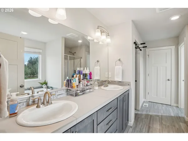 a bathroom with a sink double vanity and a mirror