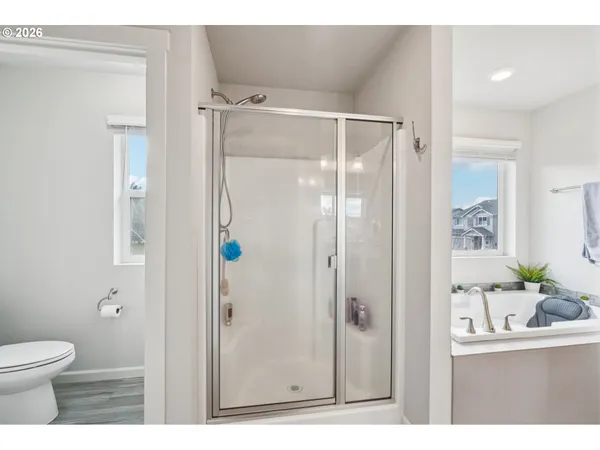 a bathroom with a shower and a sink