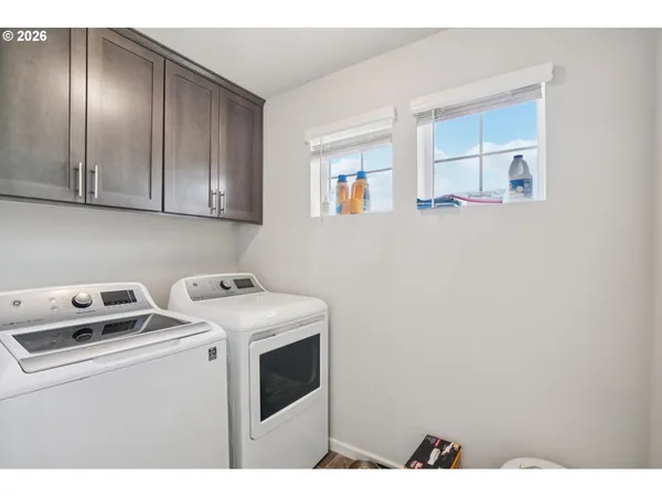 a view of an empty room with cabinet and mirror