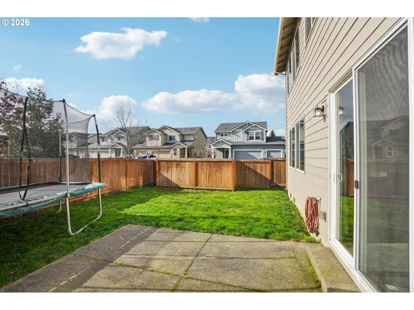 a view of a house with a yard and sitting area