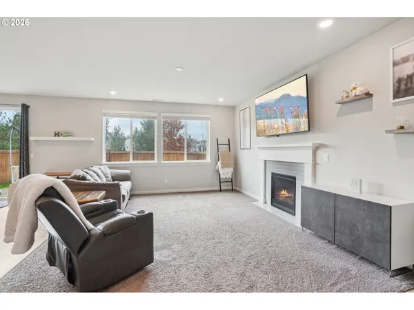 a living room with furniture a window and a fireplace