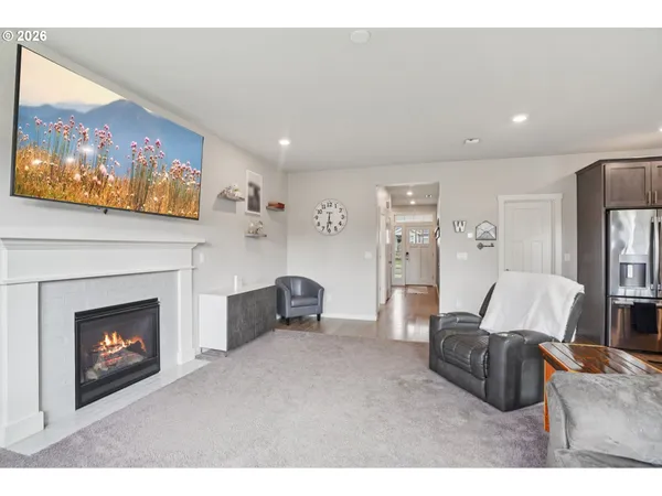 a living room with furniture a flat screen tv and a fireplace