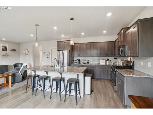 a large kitchen with a table and chairs