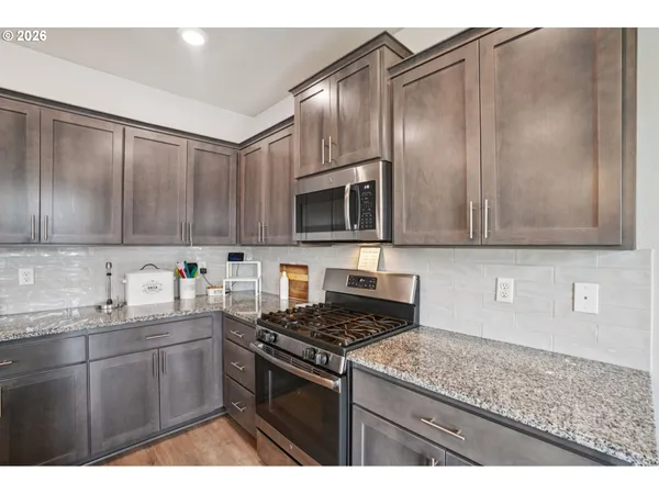 a kitchen with sink cabinets and stainless steel appliances