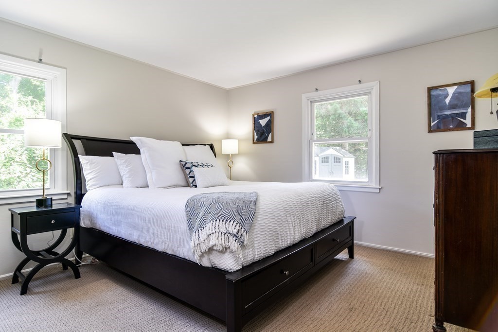 9 Braemore Road Natick, MA 01760 - Photo 12 of 24 a bed sitting in a bedroom next to a window