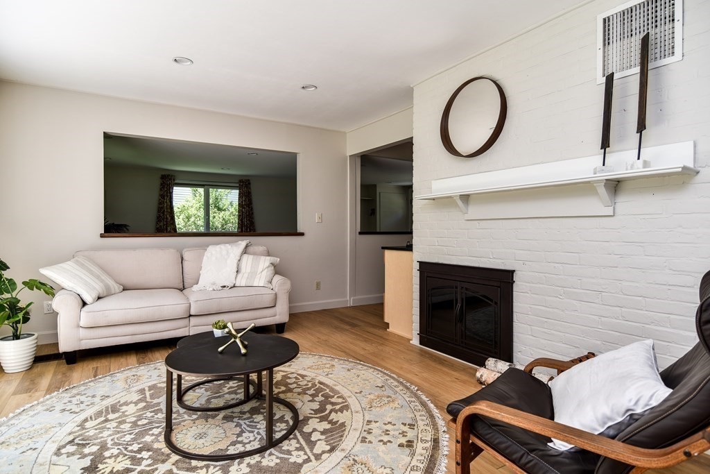 9 Braemore Road Natick, MA 01760 - Photo 13 of 24 a living room with furniture a fireplace and a flat screen tv
