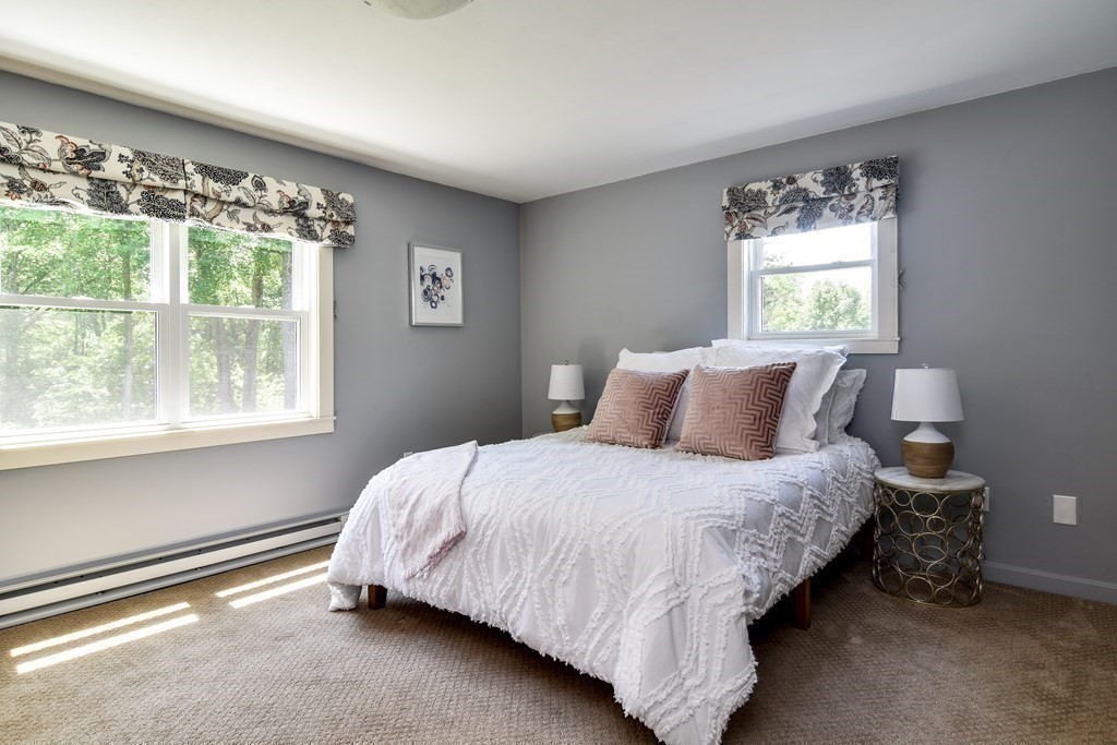 9 Braemore Road Natick, MA 01760 - Photo 19 of 24 a bedroom with a bed lamp and window