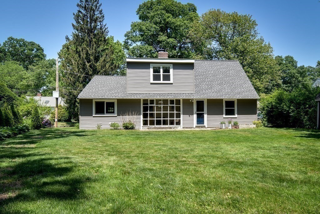 9 Braemore Road Natick, MA 01760 - Photo 20 of 24 a front view of a house with a garden