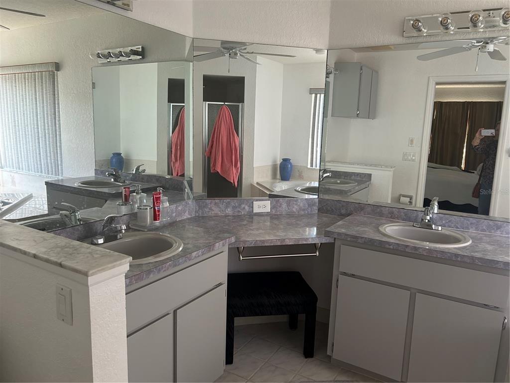 9376 Southern Belle Drive Weeki Wachee, FL 34613 - Photo 9 of 12 a bathroom with a sink and a mirror