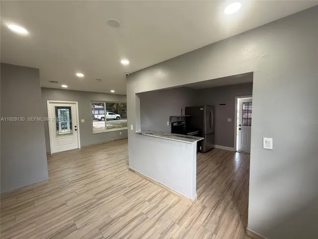 a view of kitchen with kitchen island microwave and stove