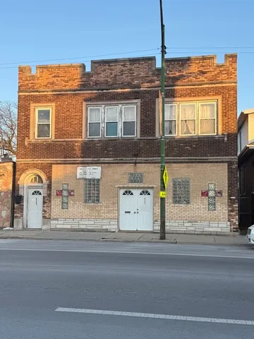 a view of a brick building next to a road
