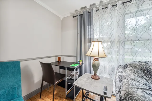 a view of a dining room with furniture and a window