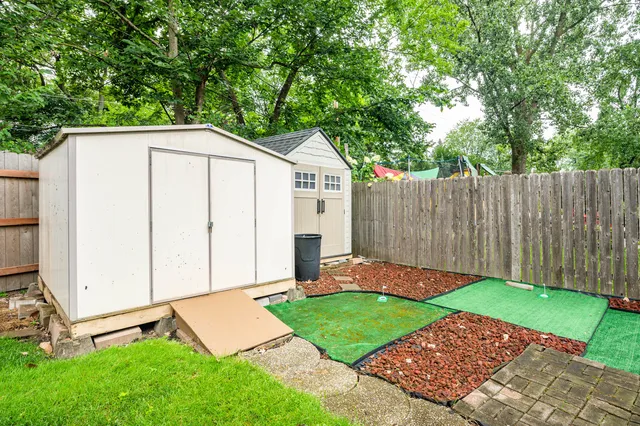a view of a backyard with a small cabin
