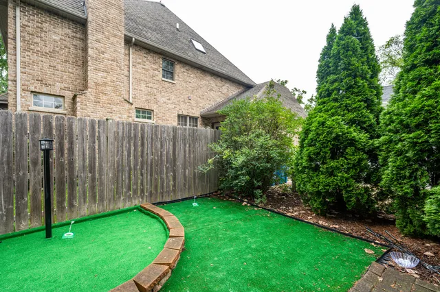 a view of a backyard with potted plants and wooden fence