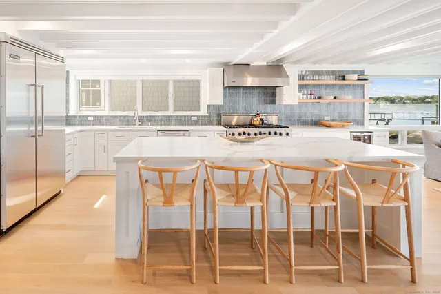 a kitchen with a table chairs and a stove