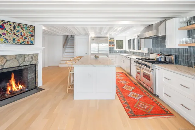 a kitchen with stainless steel appliances granite countertop a stove and a sink
