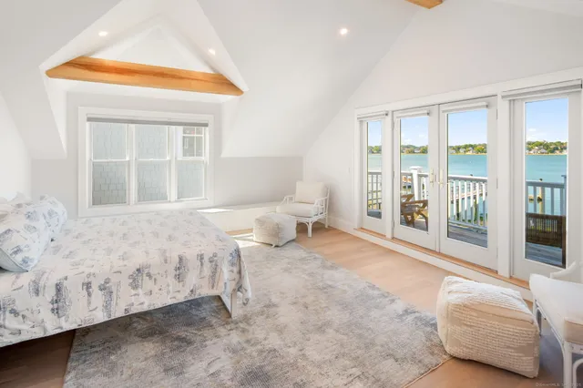 a spacious bedroom with a bed and a window