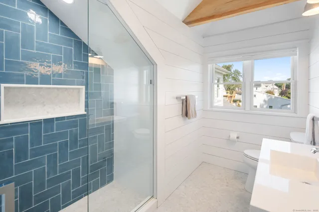 a bathroom with a bathtub and window