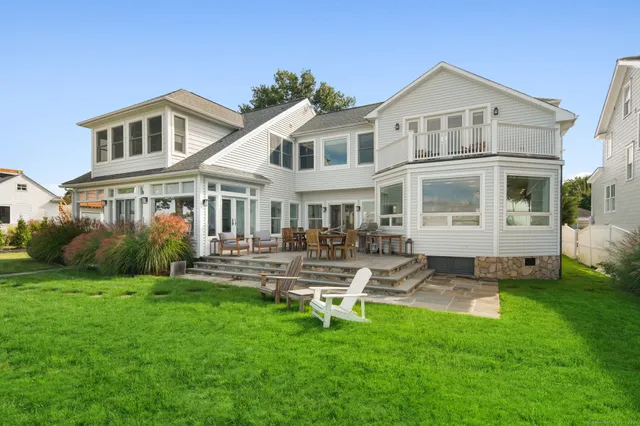 a front view of a house with a yard table and chairs