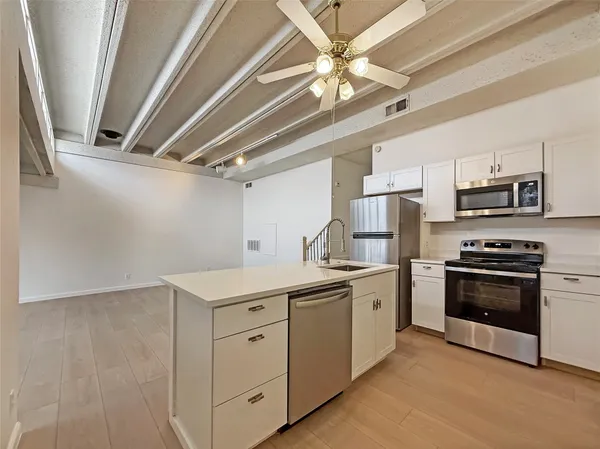 a kitchen with stainless steel appliances a sink and a stove