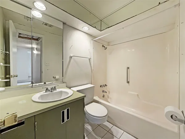 a bathroom with a sink toilet a mirror and shower
