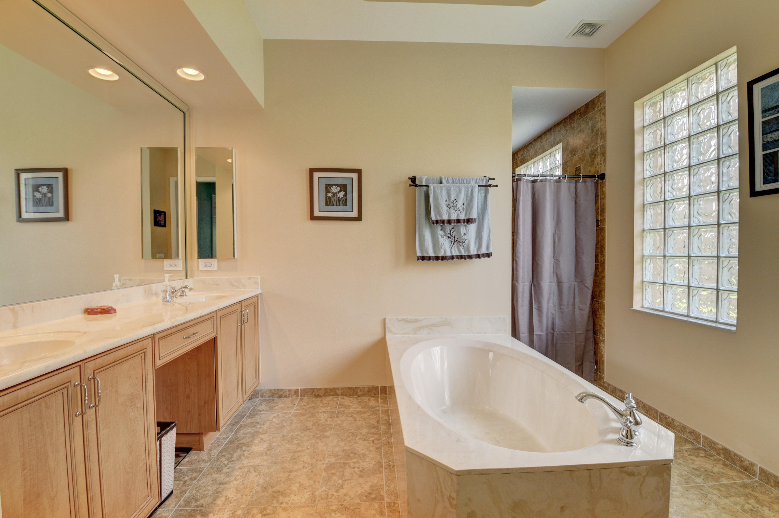 16155 Rosecroft Terrace Delray Beach, FL 33446 - Photo 16 of 40 a spacious bathroom with a tub sink and mirror