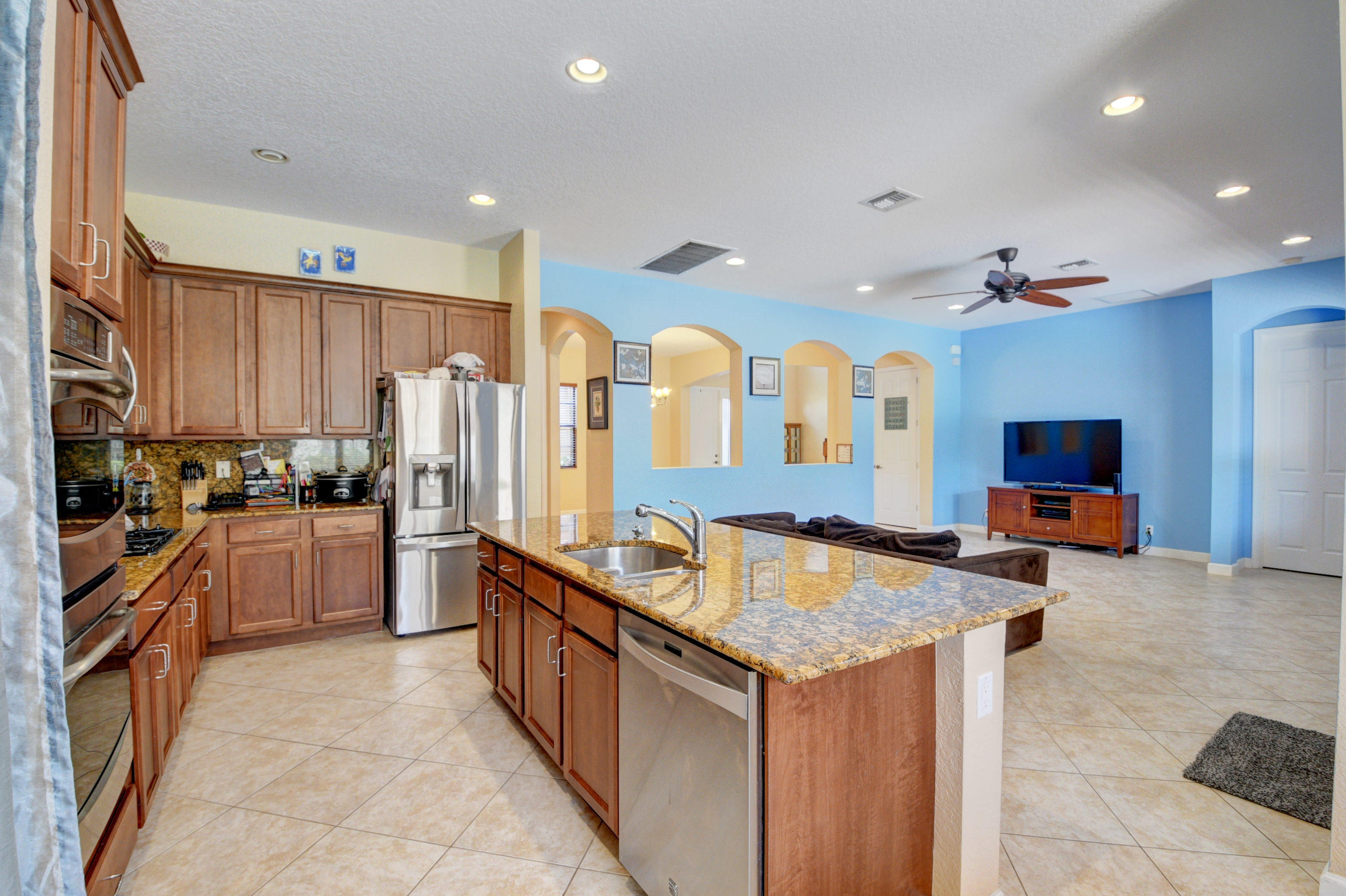 16155 Rosecroft Terrace Delray Beach, FL 33446 - Photo 6 of 40 a kitchen with stainless steel appliances granite countertop a refrigerator a stove and a sink
