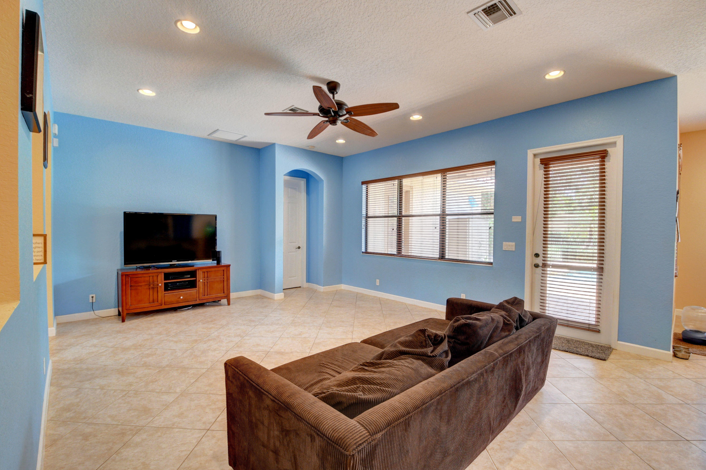 16155 Rosecroft Terrace Delray Beach, FL 33446 - Photo 8 of 40 a living room with furniture and a flat screen tv