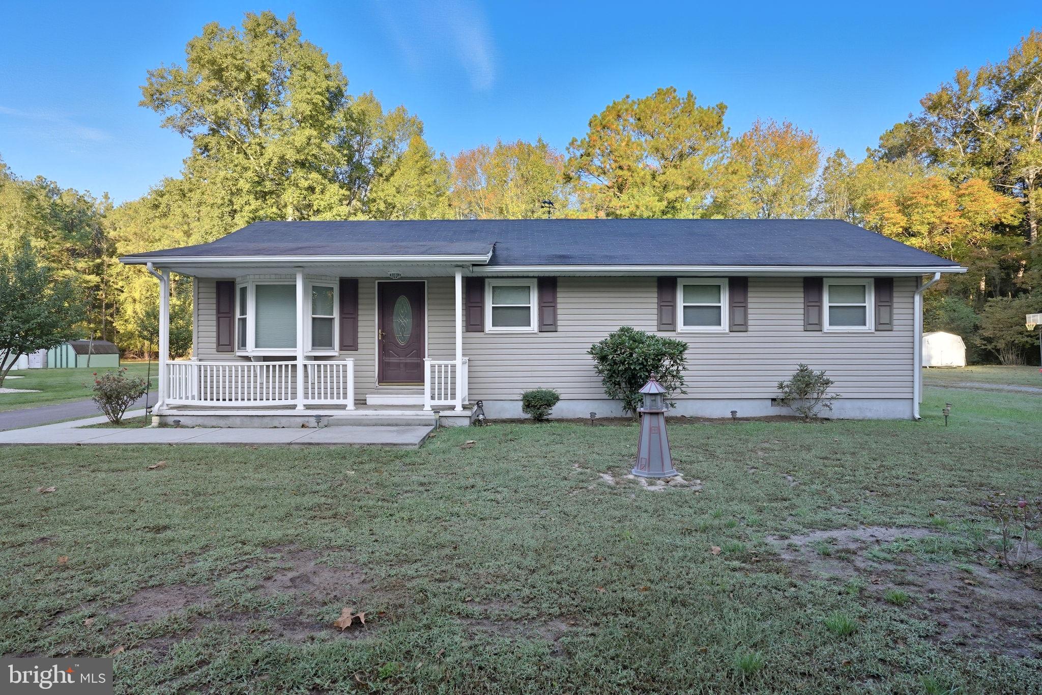 a view of a house with backyard and a tree