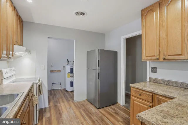 a kitchen with a refrigerator stove and sink