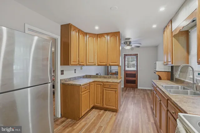 a kitchen with a sink appliances and cabinets