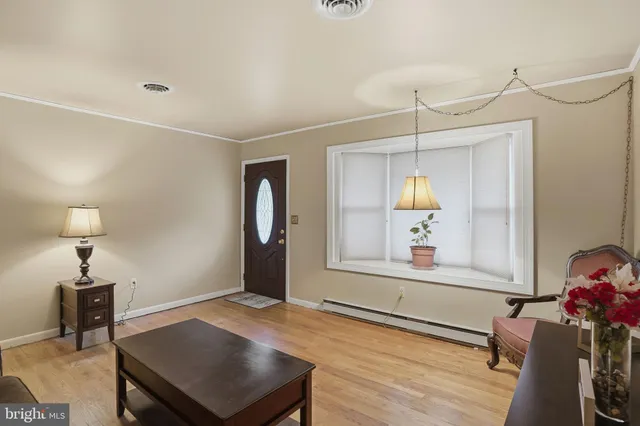 a view of a room with a window and wooden floor