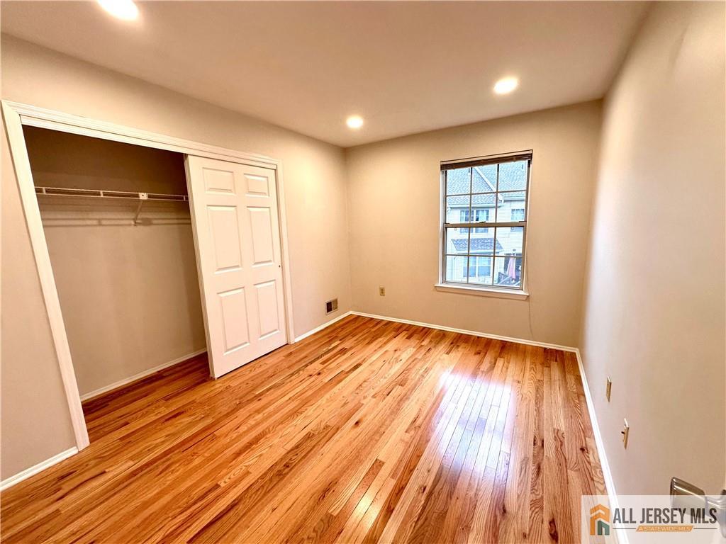 162 Salem Road North Brunswick, NJ 08902 - Photo 6 of 17 an empty room with wooden floor and windows
