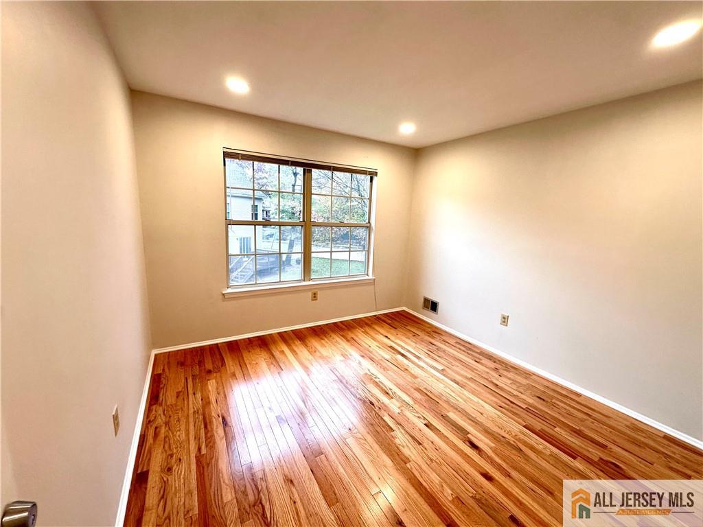 162 Salem Road North Brunswick, NJ 08902 - Photo 7 of 17 an empty room with wooden floor and windows
