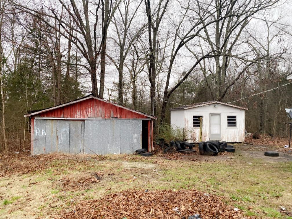 680 Austin Road Reagan, TN 38368 - Photo 4 of 12 a white house that has a tree in front of it