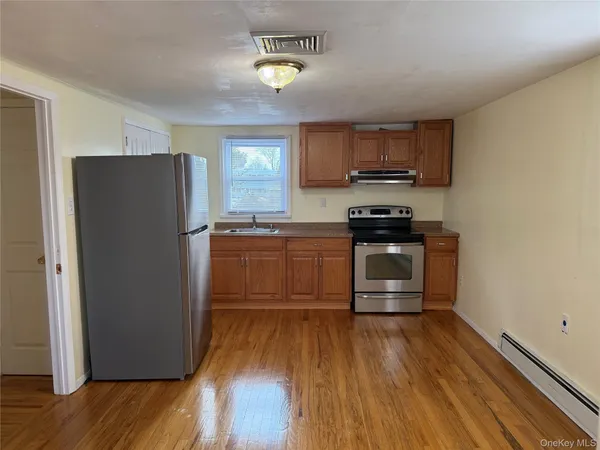 a kitchen with a refrigerator and a stove top oven