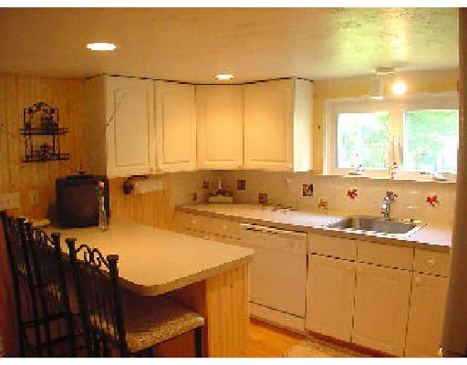 9 Seamore Road Scituate, MA 02066 - Photo 3 of 4 a kitchen with a sink appliances and cabinets