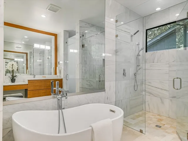 a bathroom with a tub a sink and shower