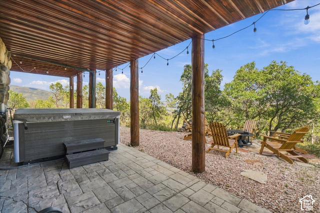 1701 Oak Road Coalville, UT 84017 - Photo 11 of 71 Covered outdoor space featuring a hot tub, stamped concrete patio, and string lighting