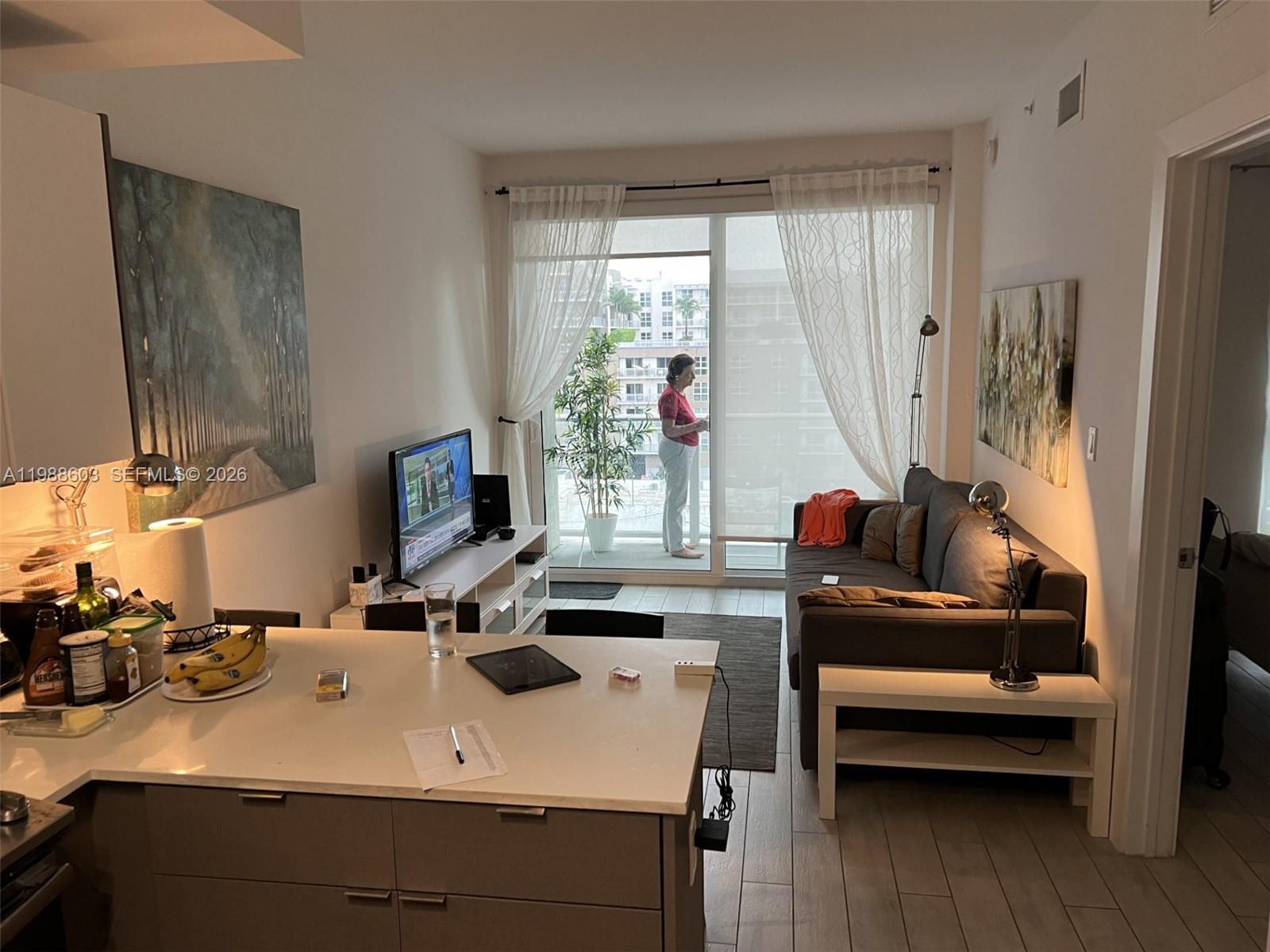 321 Northeast 26th Street, Unit 704 Miami, FL 33137 - Photo 2 of 9 a view of a workspace with furniture and a window