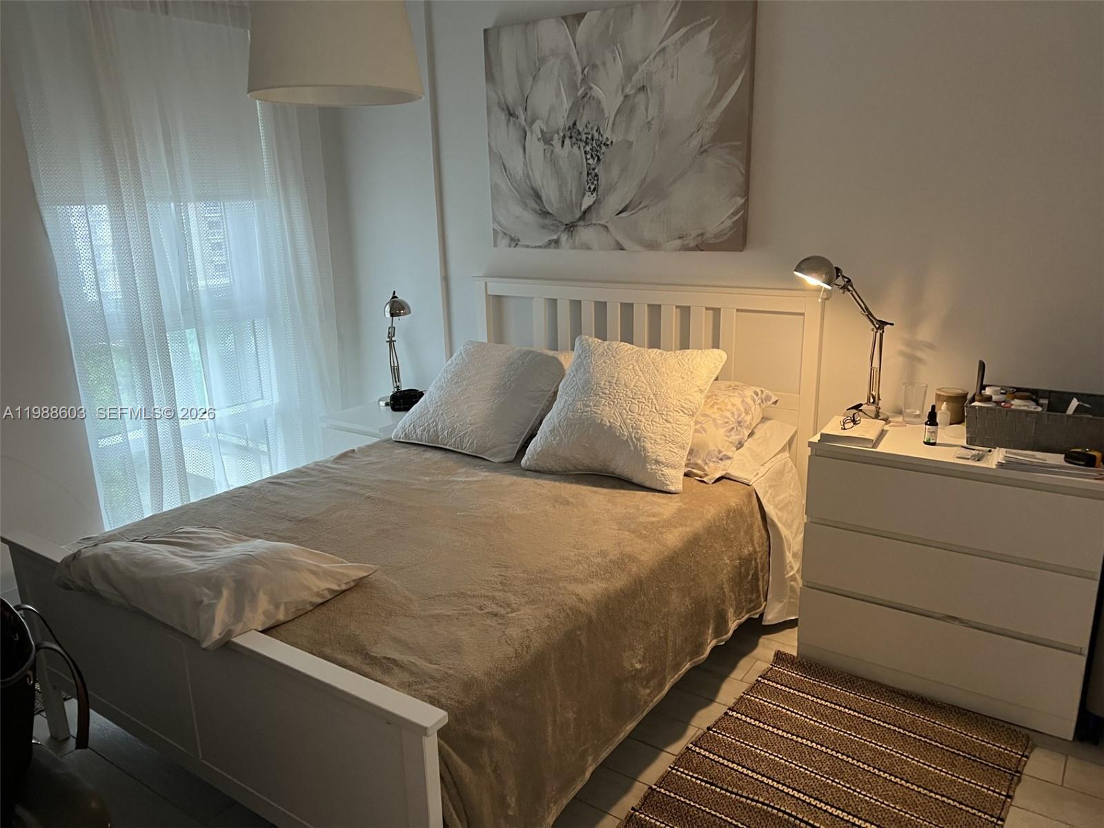 321 Northeast 26th Street, Unit 704 Miami, FL 33137 - Photo 5 of 9 a bedroom with a bed and a mirror