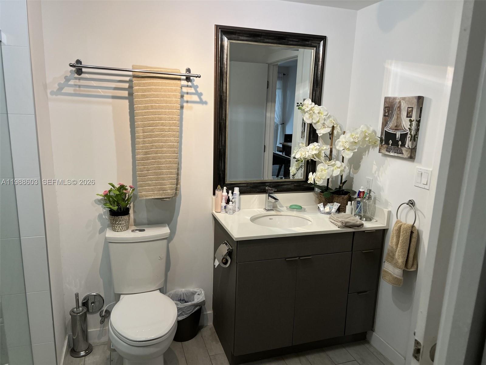 321 Northeast 26th Street, Unit 704 Miami, FL 33137 - Photo 6 of 9 a bathroom with a toilet sink and mirror