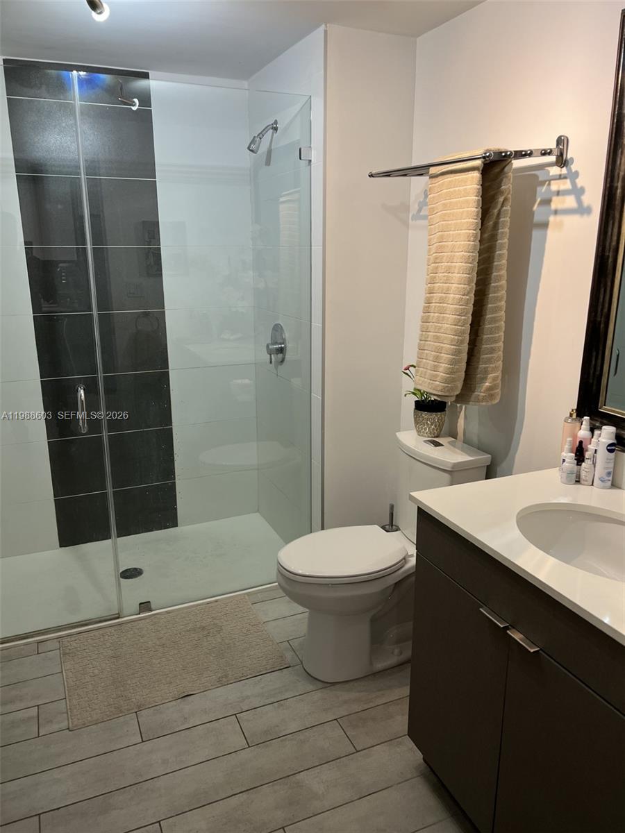 321 Northeast 26th Street, Unit 704 Miami, FL 33137 - Photo 7 of 9 a bathroom with a sink and a mirror