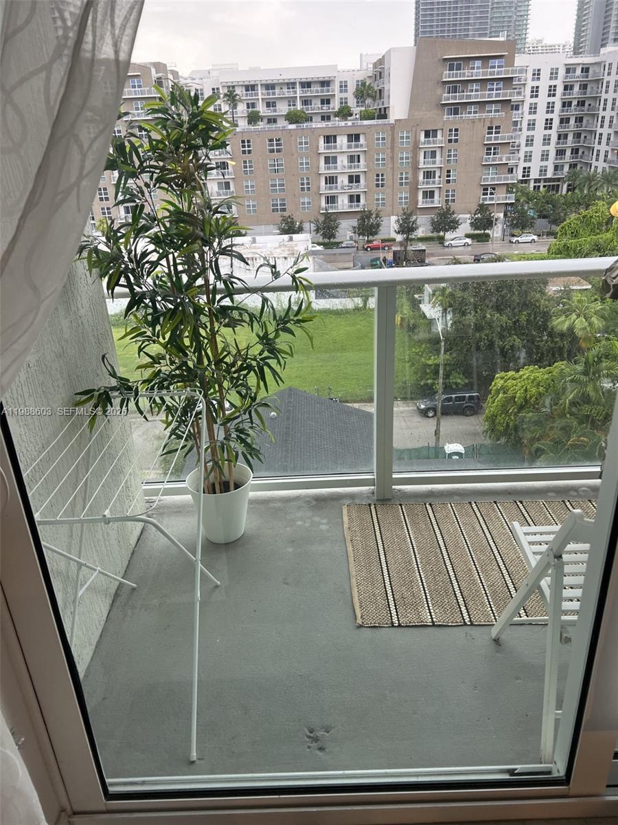 321 Northeast 26th Street, Unit 704 Miami, FL 33137 - Photo 8 of 9 a view of balcony with furniture