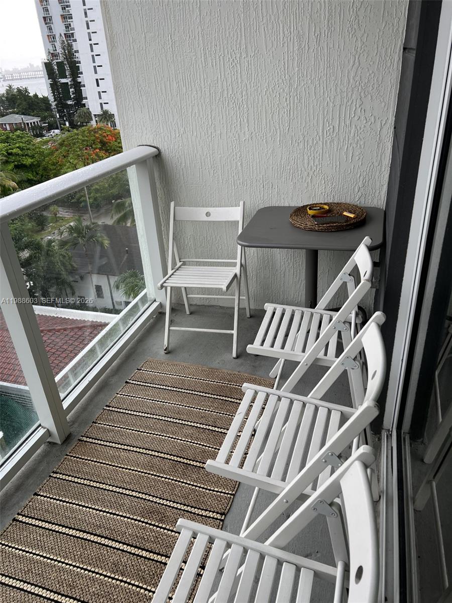 321 Northeast 26th Street, Unit 704 Miami, FL 33137 - Photo 9 of 9 a view of a chairs and table on the roof deck