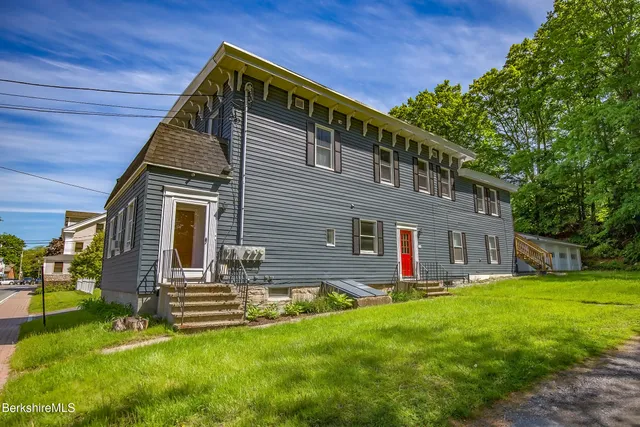 a view of house with backyard