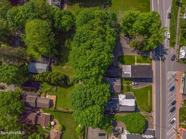 an aerial view of a house with a yard basket ball court and outdoor seating