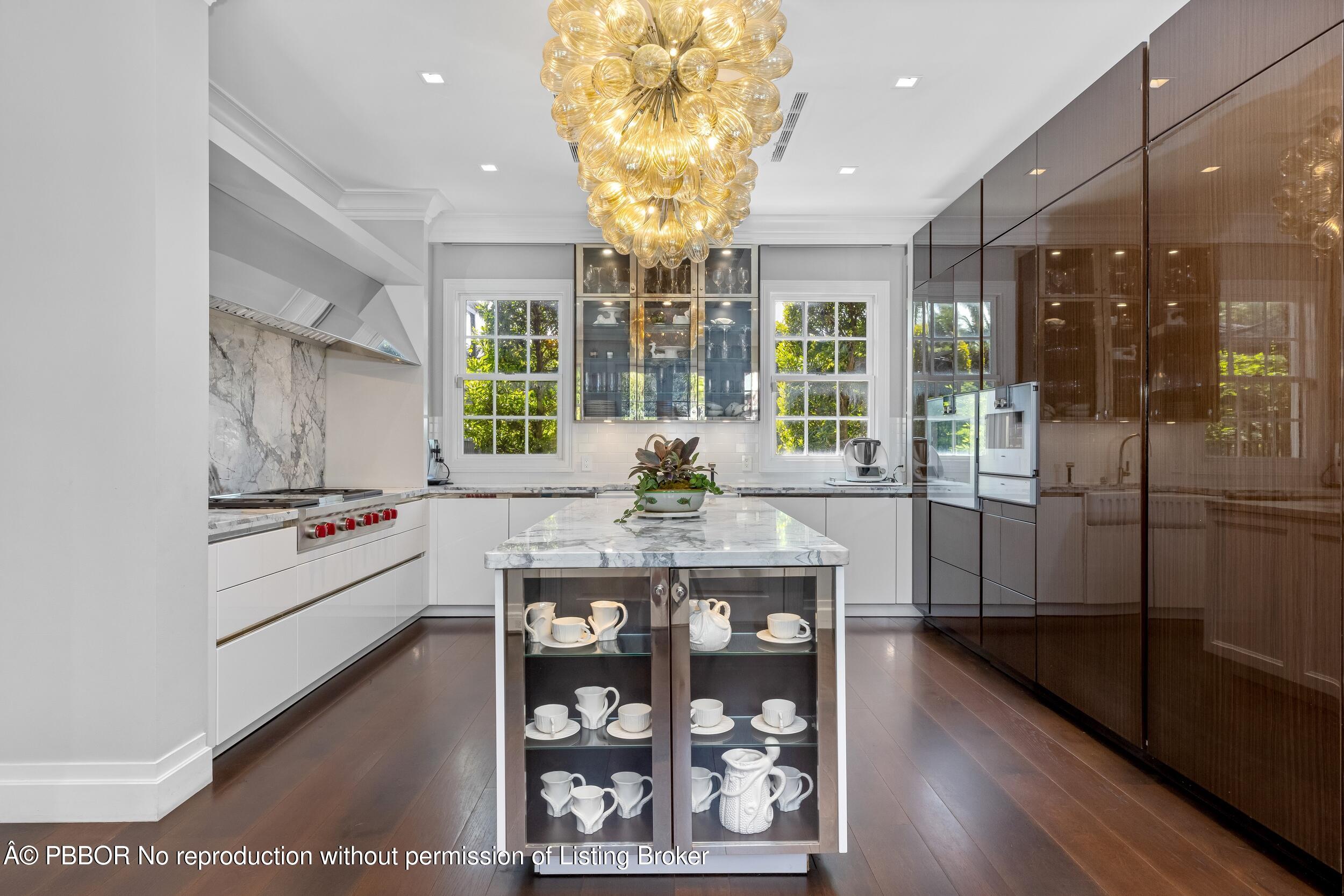 1053 North Lake Way Palm Beach, FL 33480 - Photo 27 of 82 a kitchen with stainless steel appliances a chandelier and wooden floor