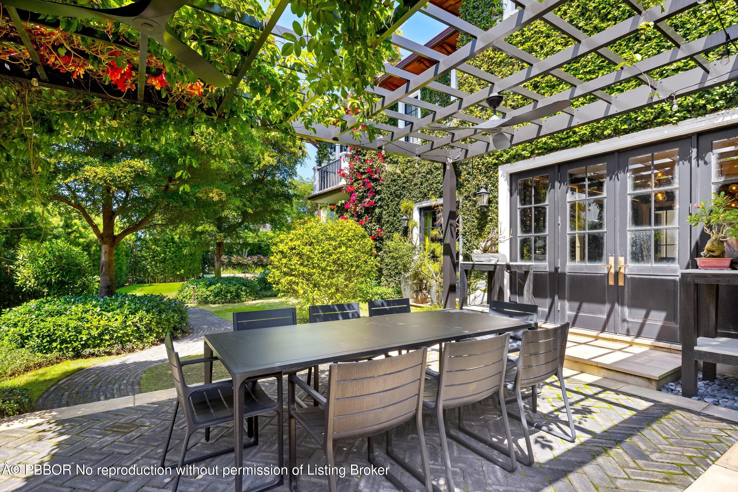 1053 North Lake Way Palm Beach, FL 33480 - Photo 56 of 82 a view of an outdoor dining space with a table and chairs