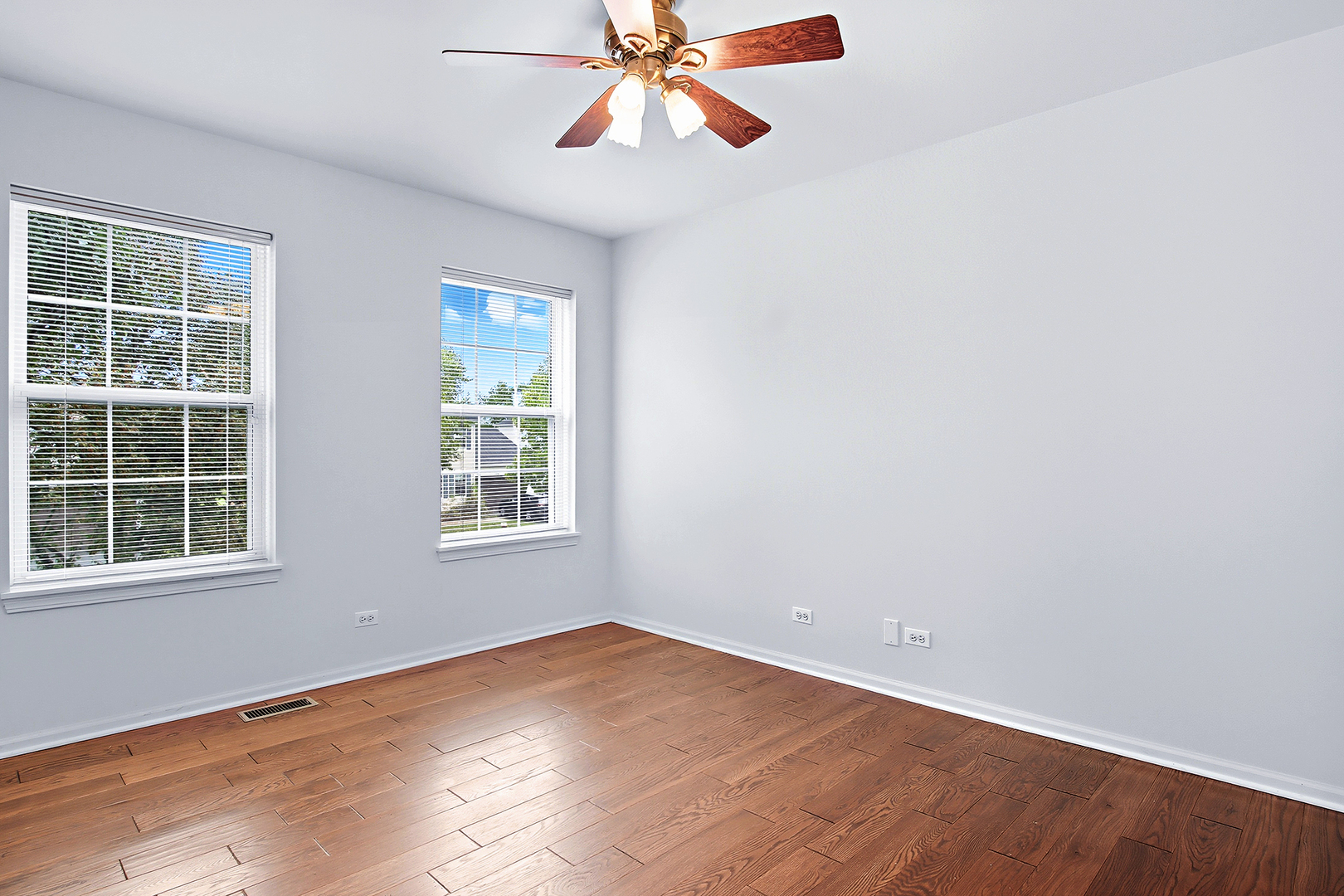 296 Foxford Drive Cary, IL 60013 - Photo 20 of 44 an empty room with window and wooden floor